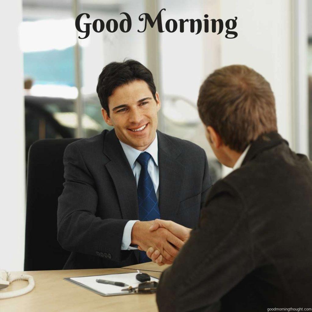 Close-up of a salesman and customer shaking hands in the office Happy Good Morning Images