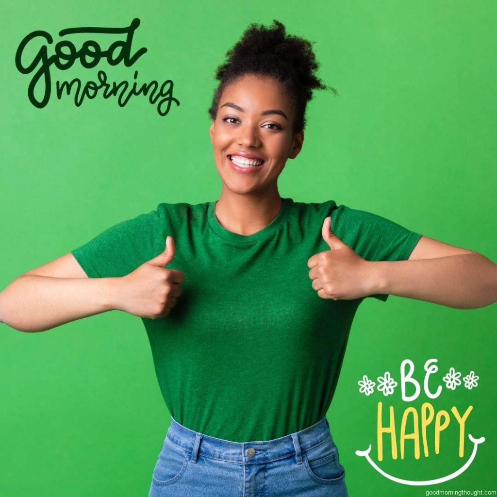 Everything Is Great. Happy African lady making thumbs up gesture standing at green studio background, _Good Morning_ text