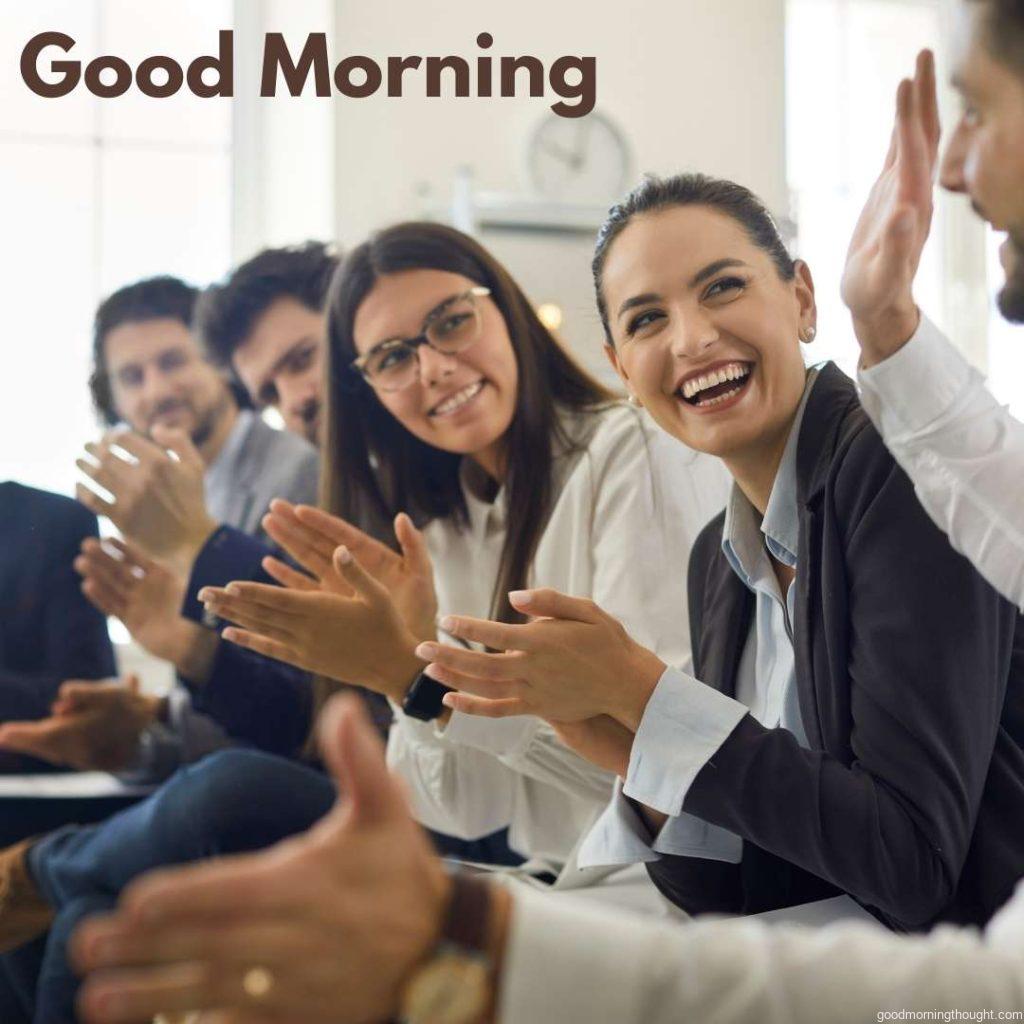 Happy Business Professionals Applauding a colleague in a presentation or Corporate Meeting, _Good Morning_ text