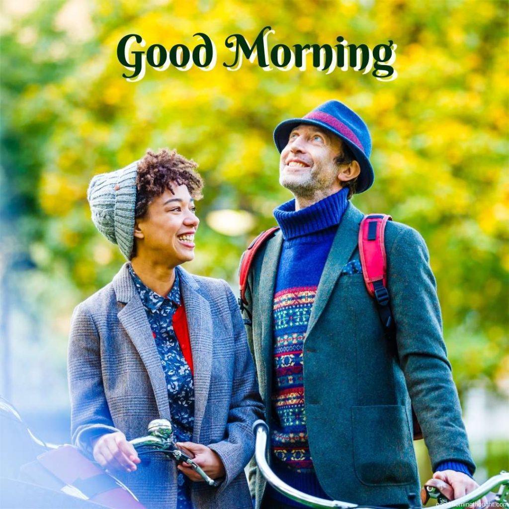 Happy couple with bicycles in the park. Happy Good Morning Images