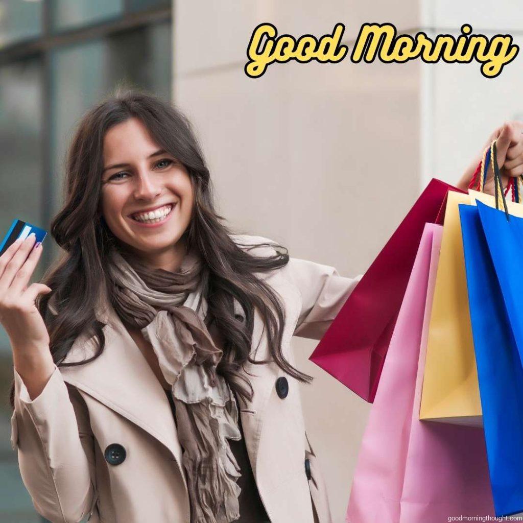 Happy shopper. Beautiful woman holding bags, Word Good Morning