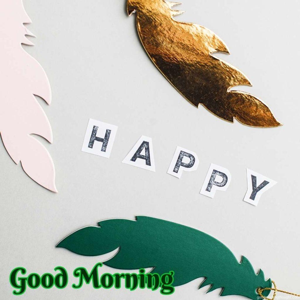 Happy text and paper feather, _Good Morning_ text