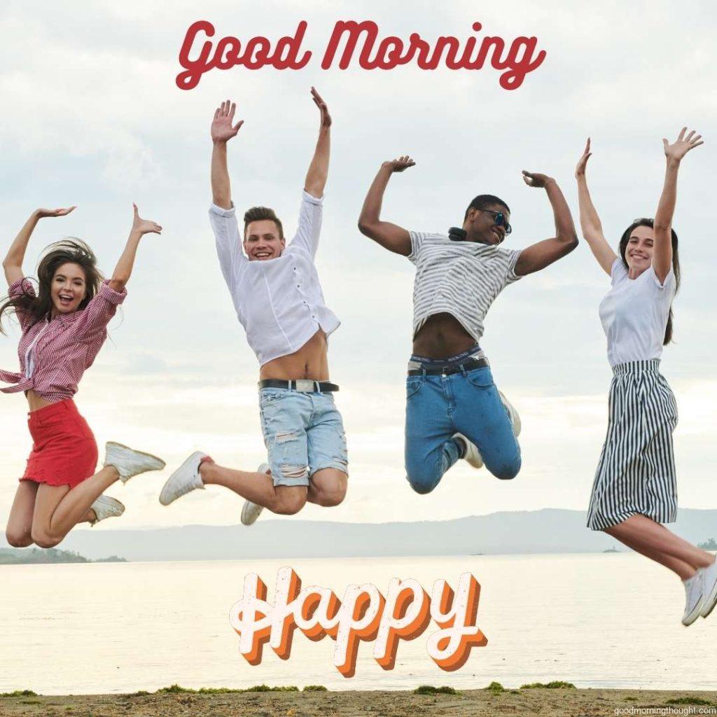 Happy young people are jumping together on the beach. Word Good Morning