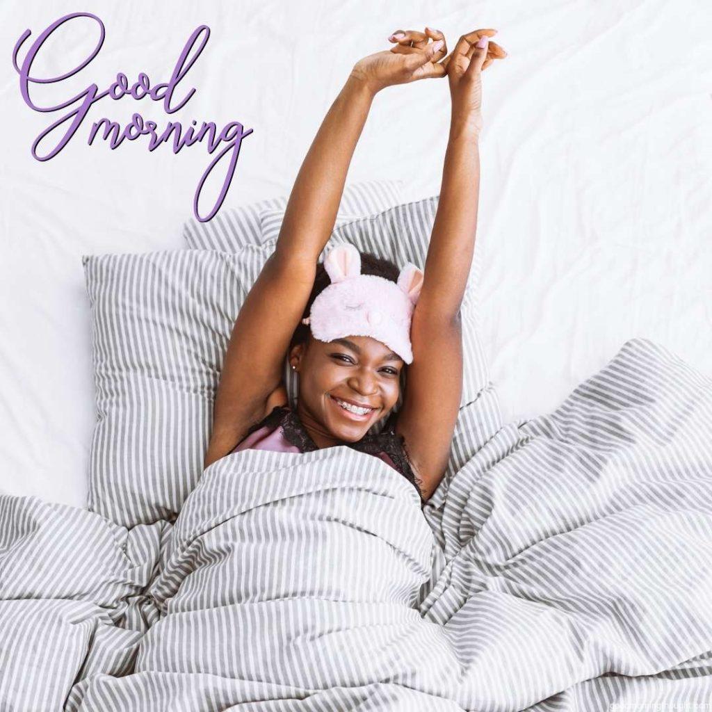 Lazy awakening, smiling African American girl in sleep mask, stretching her body, Good morning text