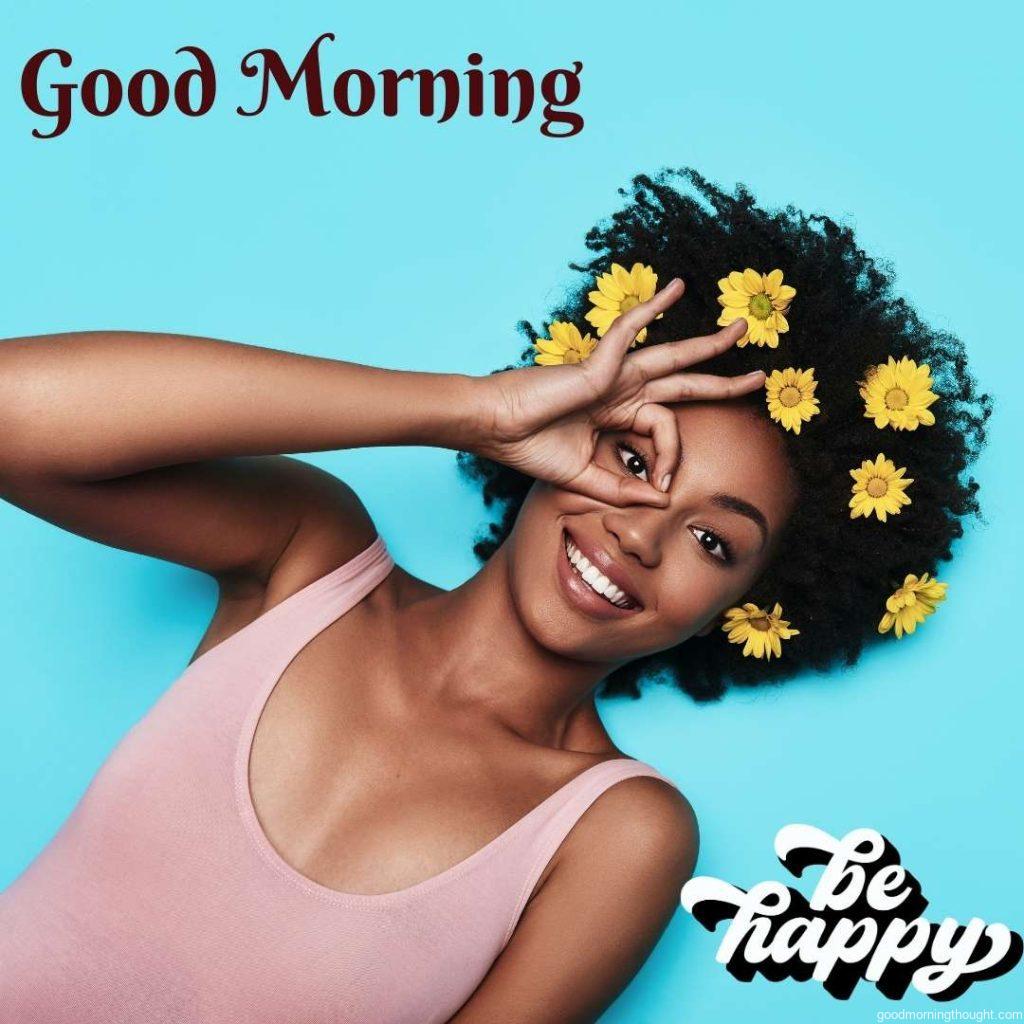 Moments of happiness Attractive young African woman looking at the camera and gesturing while lying against a blue background, Word Good Morning