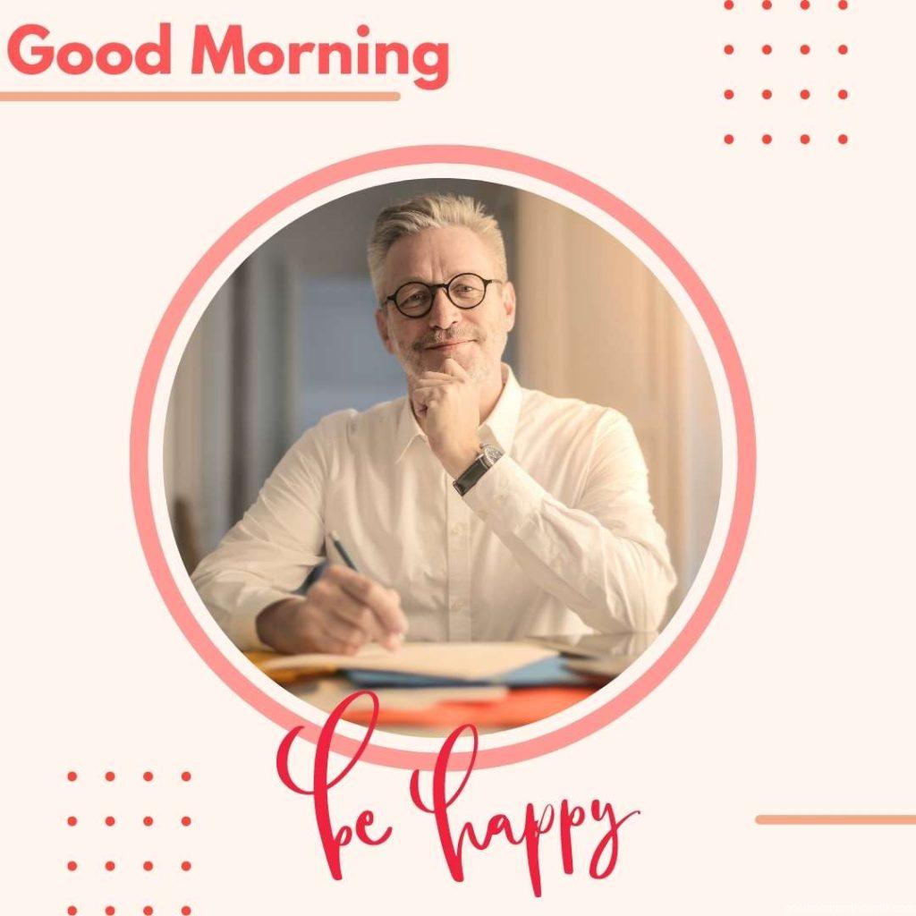 Portrait of a smiling man sitting on his office table Happy Good Morning Images