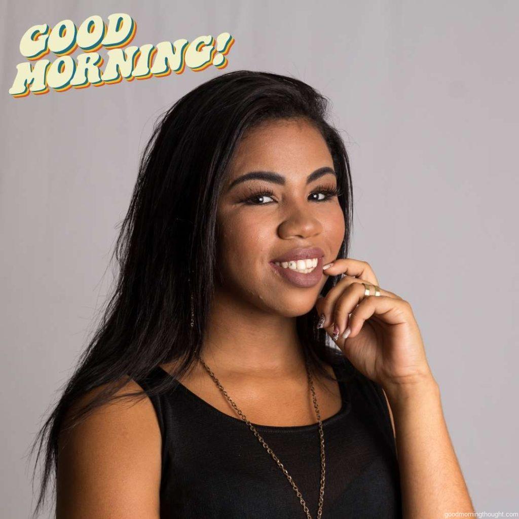 Portrait of an African American woman with straight hair looking happily into the camera, Good Morning Text