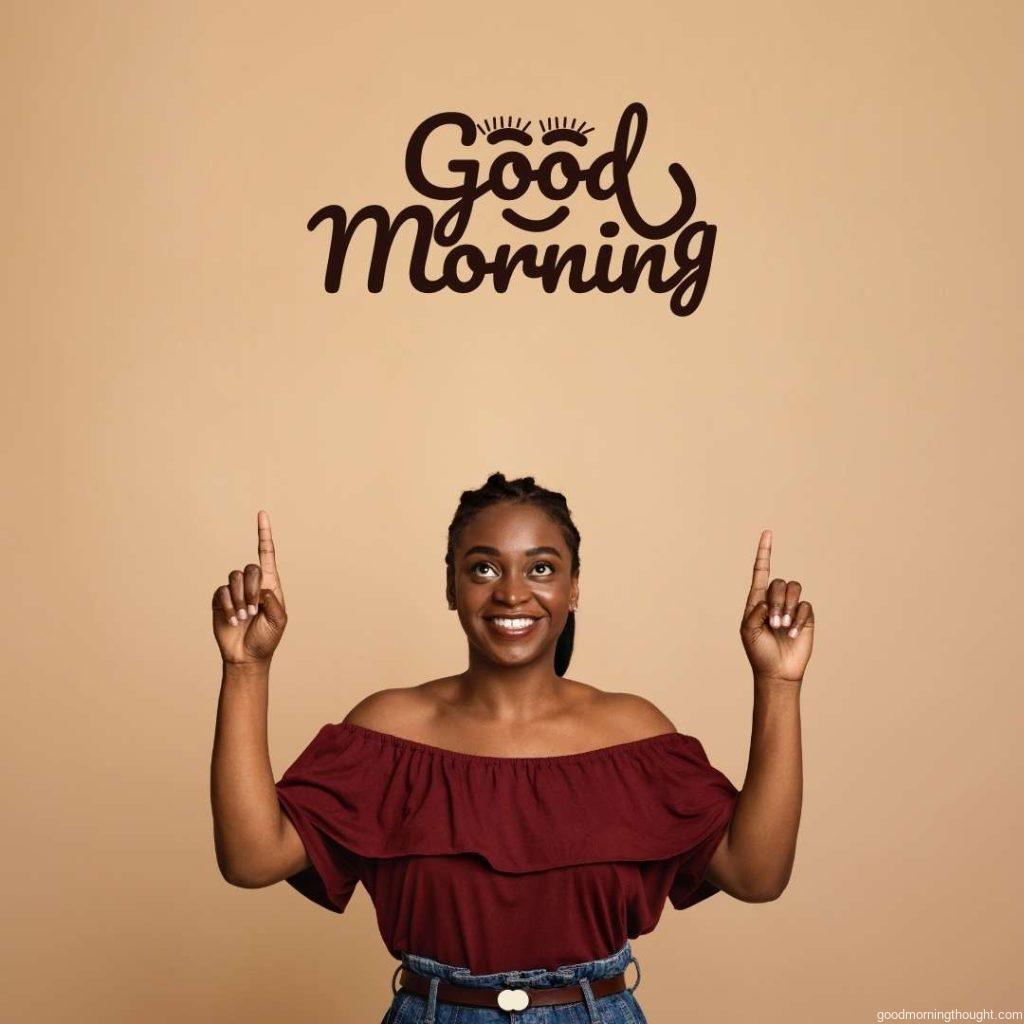 Positive African American young woman, pointing with both hands and looking up, Good morning text, African American Good Morning Images