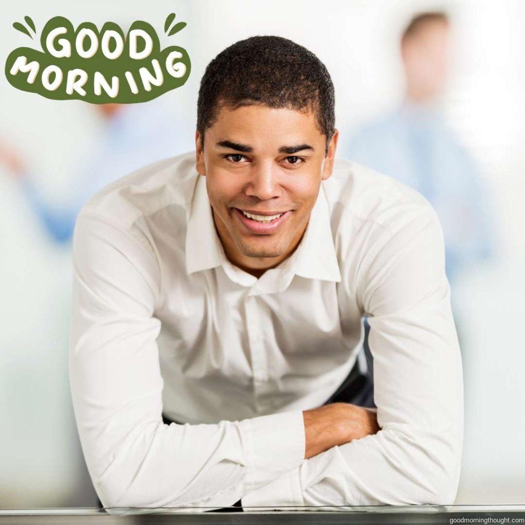 a smiling African American businessman looking at the camera. Good Morning Text